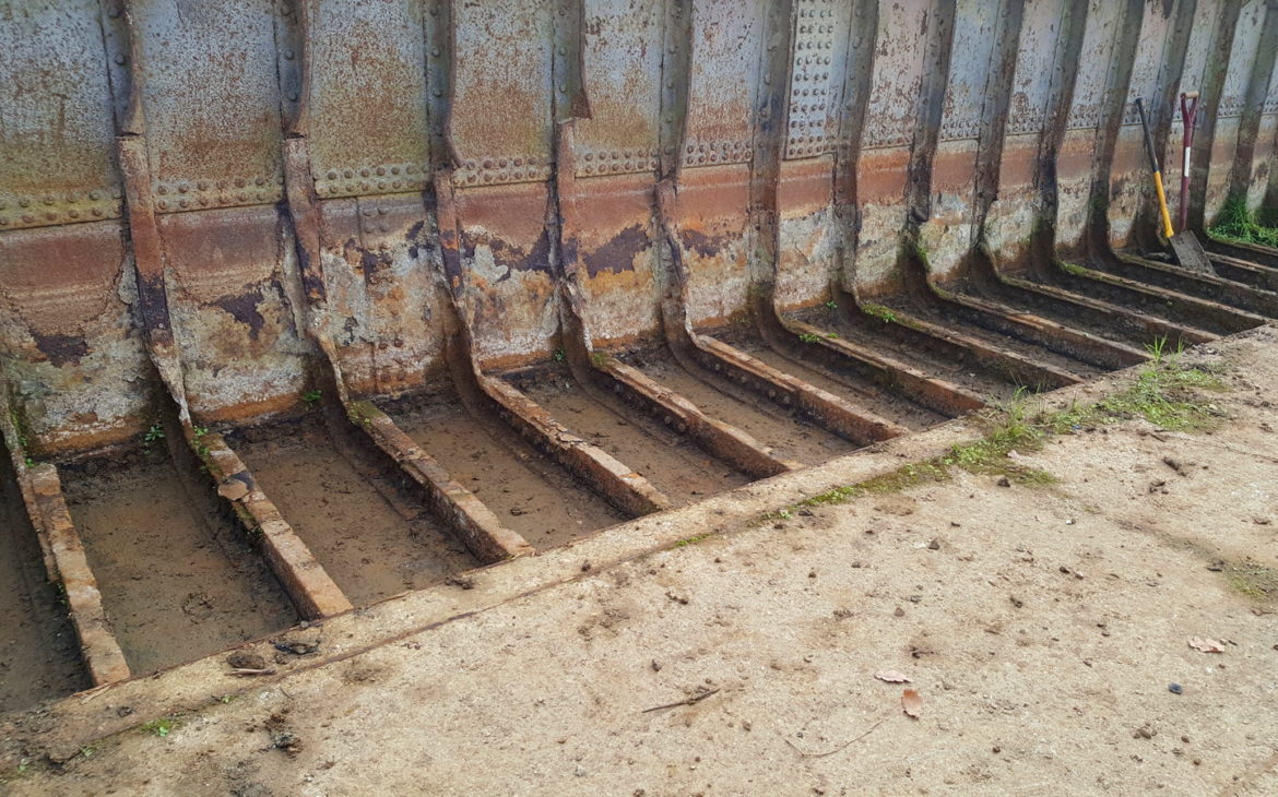 Earth cleared from barge ribs
